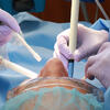 DentistAndAssistantWithPpeTreatingPatient_12mView_0.jpg